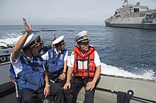 Members of the Vietnam People's Navy waving goodbye to the crew of the U.S. Navy's USS Coronado after an exchange between the two navies, 10 July 2017 Members of the Vietnam People's Navy wave goodbye to USS Coronado. (35489649690).jpg