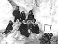 Nine fur-dressed children (one on sled) next to an ice hummock, Nome, April 23, 1910 (AL+CA 6209).jpg