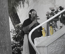 The Way of Humility: Russian Orthodox nun working at Ein Karem, Jerusalem Nun flowers black white.JPG
