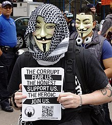 A member holding an Anonymous flier at Occupy Wall Street, a protest that the group actively supported, September 17, 2011 Occupy Wall Street Anonymous 2011 Shankbone.JPG