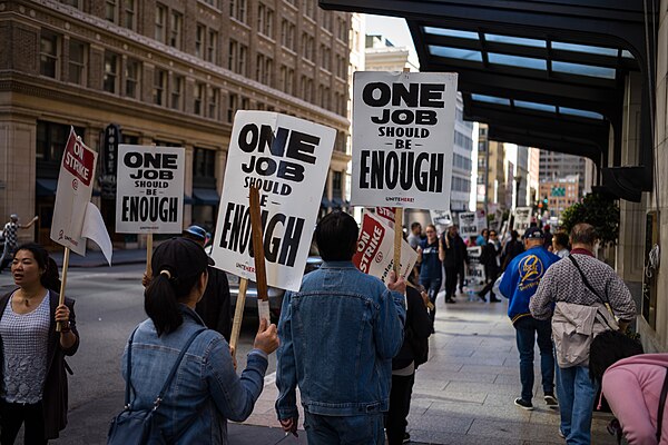 Hotel union workers strike with the slogan "One job should be enough"