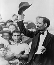 Don Pedro Albizu Campos, leader of the Nationalist Party, 1936 Pedro Albizu Campos raising his hat to a crowd, 1936.jpg