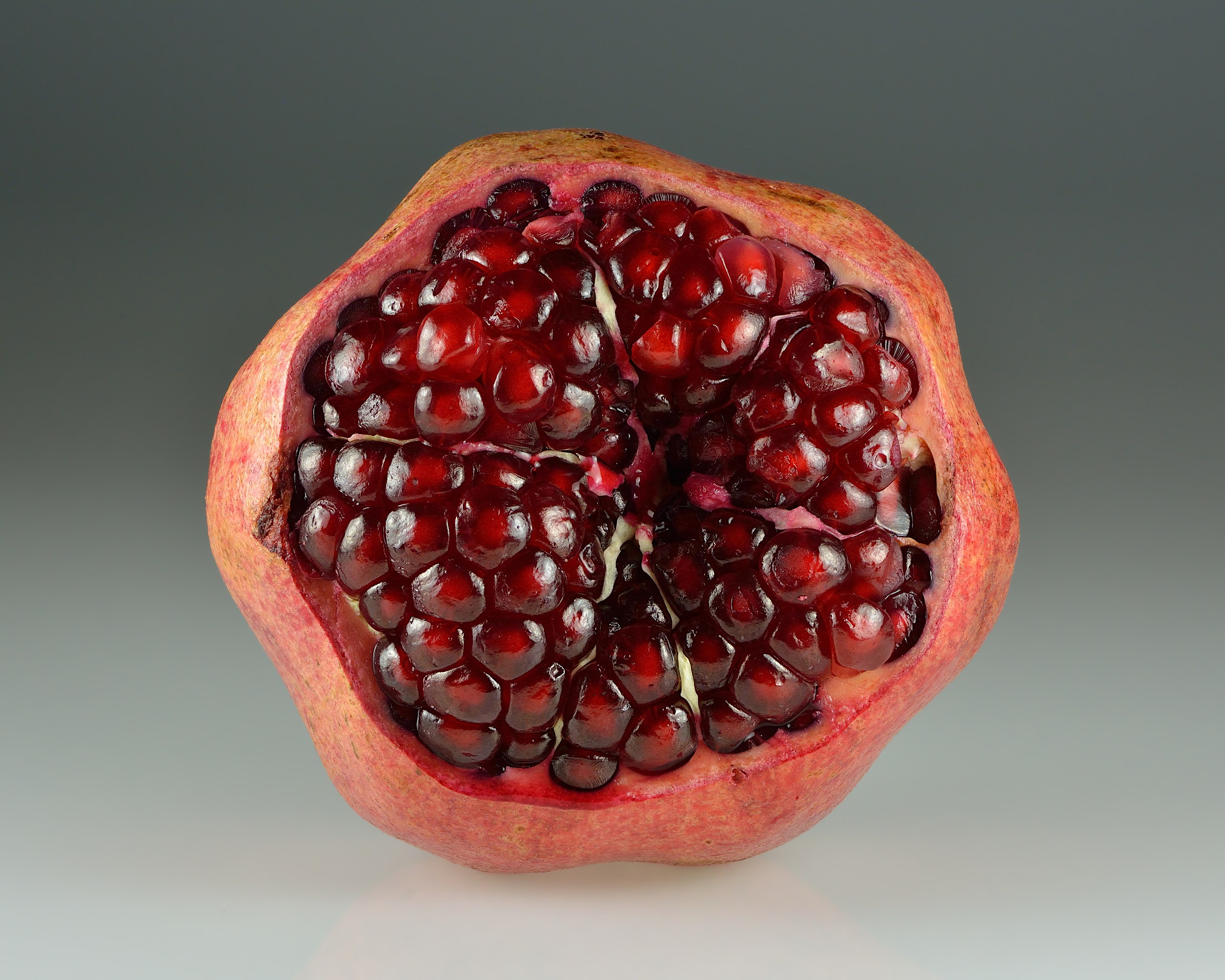 Can opener and pomegranate - open pomegranate for juice Stock Photo - Alamy