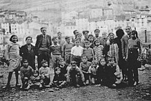 A group of children, with two adults