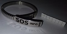 Some medical alert bracelets have an openable hatch, that contains a multifolded waterproof paper, in which information about persons medical needs are written. SOS-bracelet.jpg