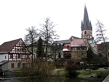 Schrepfersmuhle (mill) and parish church with charnel house, seen from the river Baunach Schrepfersmmuehle und Pfarrkirche.jpg