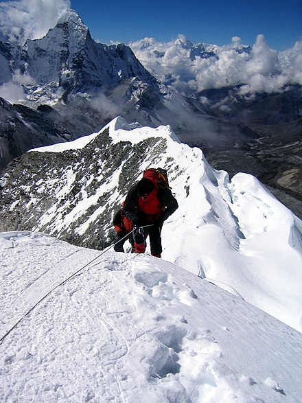 A climber taking the final few steps onto the 6,160 m (20,210 ft)[1] summit of Imja Tse (Island Peak) in Nepal, 2004