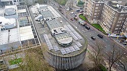 A bird's eye photo shows the length of Swiss Cottage library, a long, pill like structure