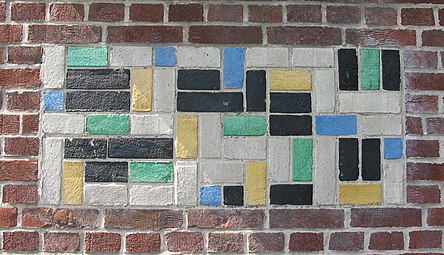 De Stijl - Panel of polychrome bricks on the exterior of the Vakantiehuis De Vonk [nl], a house in Noordwijkerhout, the Netherlands, by Theo van Doesburg, 1917-1919[73]