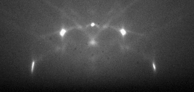 Figure 6. A RHEED pattern from a TiO2 (110) surface with visible Kikuchi lines. The Kikuchi lines pass through the Laue circles and appear to radiate from the center of the pattern. TiO2 Surface with Kikuchi Lines.gif