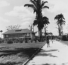 Indian indentured laborers worked for decades for meagre wages in sugar cane plantations of the Dutch East Indies. This image from Tropenmuseum Royal Tropical Institute shows two Indo-Caribbean people walking towards the house of a Dutch engineer in a Caribbean sugar cane plantation. Tropenmuseum Royal Tropical Institute Objectnumber 20007183 De woning van de werktuigkundige op d.jpg