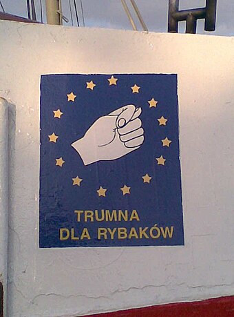 "Trumna dla rybaków" ("Coffin for fishermen"). A sign visible on the sides of many Polish fishing boats. It depicts an obscene Slavic gesture. Polish fishermen protest against the EU's prohibition of cod fishing on Polish ships.