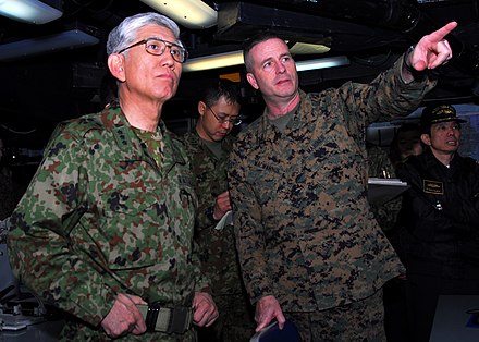 JGSDF Chief of Staff Eiji Kimizuka, speaks with a U.S. Marine officer aboard the USS Essex (LHD-2), in March 2011