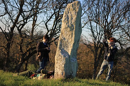 Wikimedians taking photos of a menhir during a photography expedition