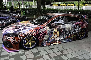 A Mazda 3 with an Itasha style wrap featuring Yamato from the video game Kantai Collection.