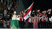 Syria with flag bearer Ahed Joughili, weightlifter and multiple medalist 2014 Asian Games opening ceremony 29.jpg