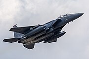 An F-15E Strike Eagle, tail number 91-0320, taking off from RAF Lakenheath in England. The aircraft is assigned to the 494th Fighter Squadron.