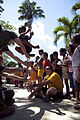 A boy at Alfonso XIII Elementary School plays a high jump game as U.S. Navy Hospital Corpsman 3rd Class Camden Boyd, sitting right, and Marine Corps Hospitalman Christopher Baldwin, sitting left, both assigned 111026-M-VG363-570.jpg