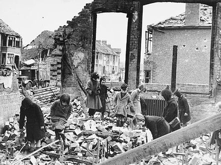 Children searching for books among the ruins of their school after the April raid