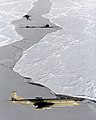 An RAF Nimrod MR2 on patrol in the skies over the ice, it is shown with two submarines just breaking through the ice. MOD 45137402.jpg