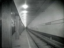 A black-and-white photo of an underground streetcar station