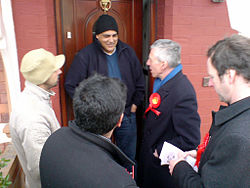 British politician Jack Straw (on the right with a red rosette) canvassing with local councilors in Blackburn, Lancashire, in 2008 Canvassing.jpg