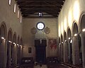 Veduta della navata centrale dall'altare maggiore. A destra del portone di ingresso l'affresco di San Cristoforo.