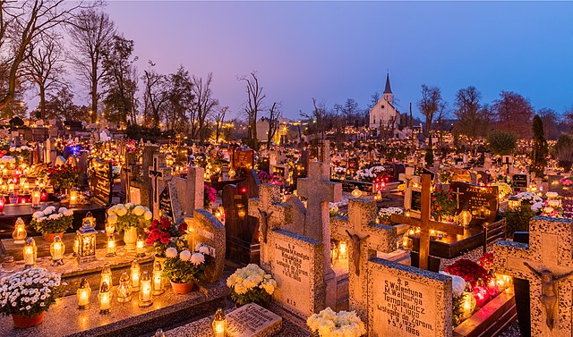 All Saints' Day at a cemetery in Gniezno, Poland – flowers and candles placed to honor deceased relatives (2017)