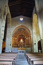 Photographie de l'intérieur d'une église non voûtée, directement couverte d'une charpente.