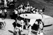 The Dymaxion car, c.1933, artist Diego Rivera shown entering the car, carrying coat.