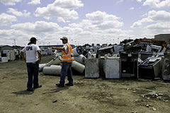 Cedar Rapids, Iowa, July 4, 2008-- EPA Federal On-Scene Coordinator John Frey, discussed an issue with a colleague in front of 'white goods' discarded household appliances; such as refrigerators, stoves, washers, dryers etc., which the EPA is responsible for recycling and disposing of FEMA - 36970 - Photograph by Susie Shapira taken on 07-04-2008 in Iowa.jpg