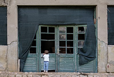 Gabriel peeking into an abandoned building, Ston, Croatia
