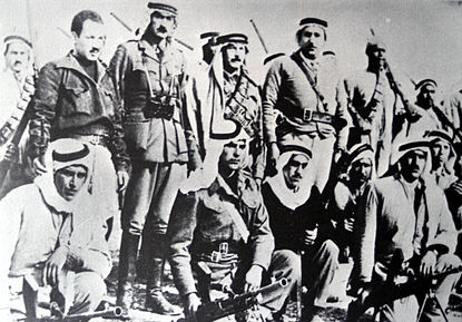 Abd al-Qadir al-Husayni returned to Palestine after an exile of ten years, and began organizing Palestinian resistance to forcible partition of the country. He is seen here (standing center) with aides and Palestinian irregulars, Jerusalem district, February 1948