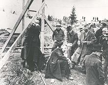 J. Allister Bowman, district plant superintendent, Maritime Tel & Tel, using earphones to listen for entombed men J. Allister Bowman, district plant superintendent, Maritime Tel & Tel, using earphones for word from entombed men in Moose River Mine Disaster, Nova Scotia, Canada, April 1936.jpg