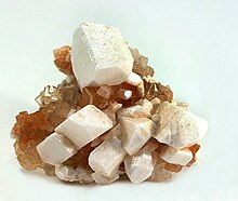 leonite as white pseudomorphs after sharp freestanding picromerite crystals sizes to 2 cm, perched on a matrix of crystallized halite. 5.5 x 4.7 x 3.4 cm