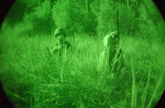 Two American soldiers pictured during the 2003 Iraq War seen through an image intensifier.