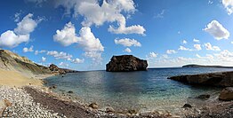 Panorama of Ħalfa Rock from the nearby beach.