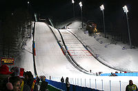 Pragelato ski jump during the 2006 Winter Olympics. The venue hosted the ski jumping and the ski jumping portion of the Nordic combined events. Pragelato olympic skijump.jpg