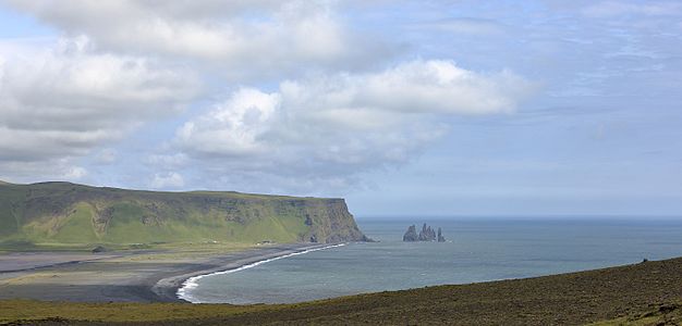 The beach of Reynisfjara and Reynisdrangar, basalt sea stacks, as seen from Dyrhólaey, Iceland