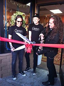 Guitarist Jake E. Lee cuts the ribbon at Cowtown's grand reopening ceremony in Las Vegas in 2012. Ribbon Cutting.jpg