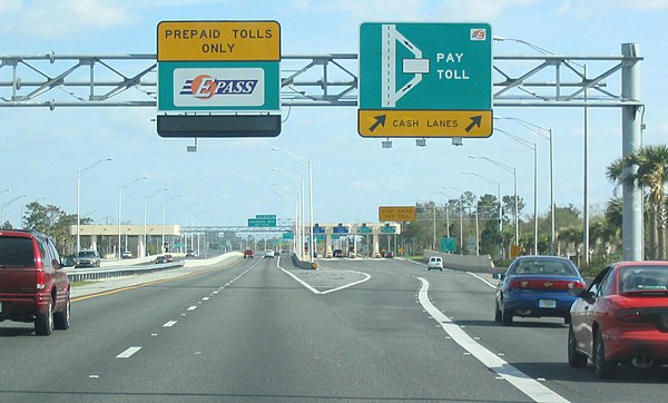 Collecting tolls on SR 417 near Orlando, Florida, United States. This shows the two common methods of collection of tolls: tollbooth (on right) and el