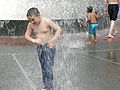 Children playing in the International Fountain.