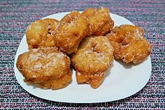 Sfenj sprinkled with sugar and served on a plate.jpg