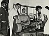 CO 1069-46-53 - Governor Charles Arden-Clark and workers on a lathe, January 1957