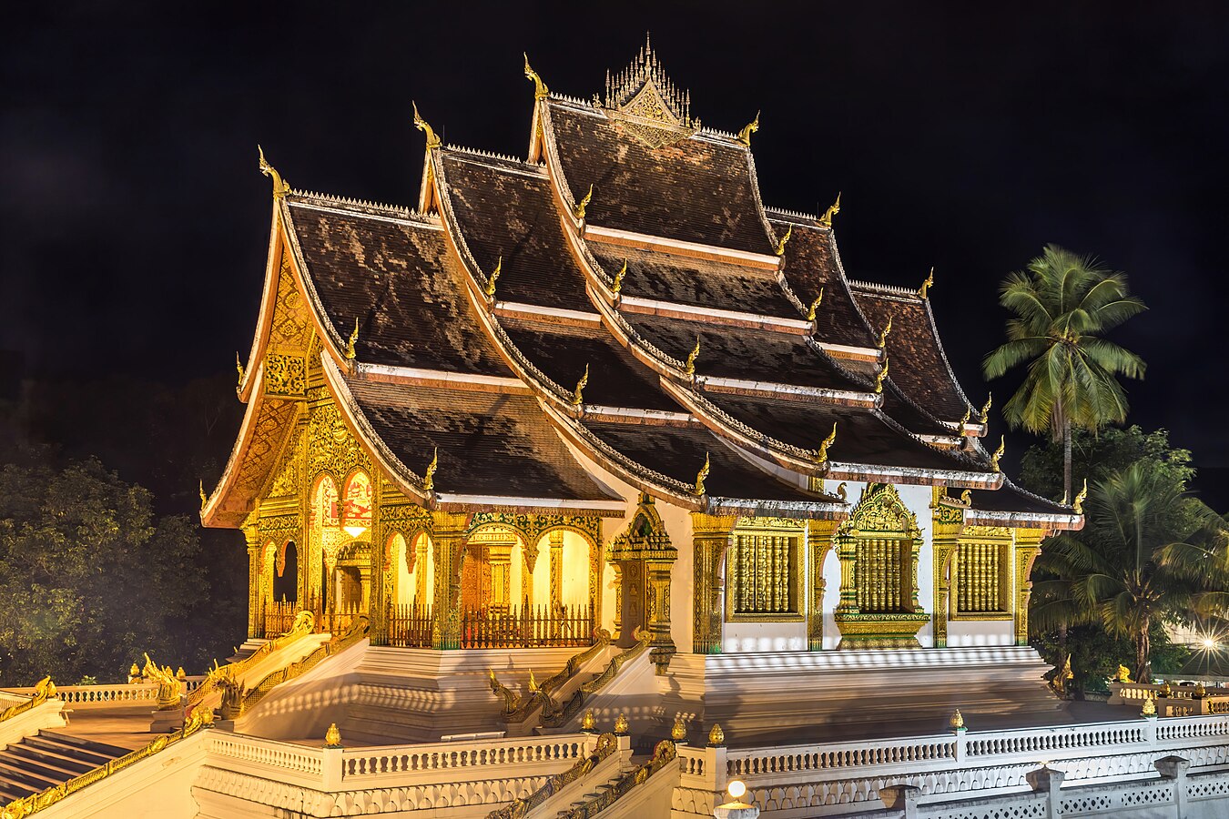 Three-quarter view of the temple Haw Pha Bang at night in Luang Prabang Laos