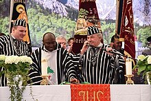 A Tiv and European Catholic priests in native Tiv attire Tiv priest.jpg