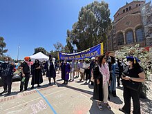Faculty members holding a banner as they support the student protestors inside the encampment UCLA FJP 2024.jpg