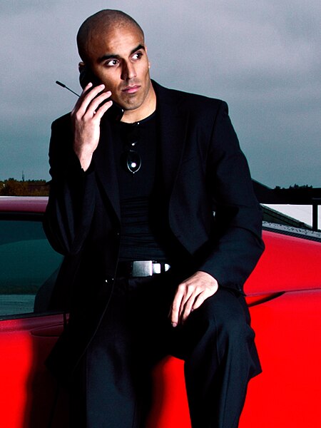 Umar Khan posing with a ferrari.jpg