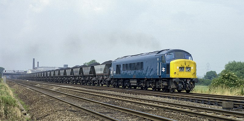 File:“Peak” Cl 45 no. 45070 with a "Merry Go Round" coal train heads south through Loughborough, Nigel Tout, 9.7.75.jpg