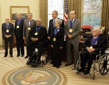 President George W. Bush stands with recipients of the 2005 National Medal of Arts on November 9, 2005, in the Oval Office. Among those recognized for their outstanding contributions to the arts were, from left: Leonard Garment, Louis Auchincloss, Paquito D'Rivera, James DePreist, Tina Ramirez, Robert Duvall, and Ollie Johnston.